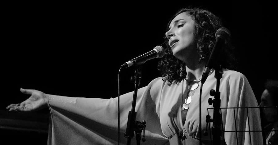 Sura performing on stage — from The National's coverage